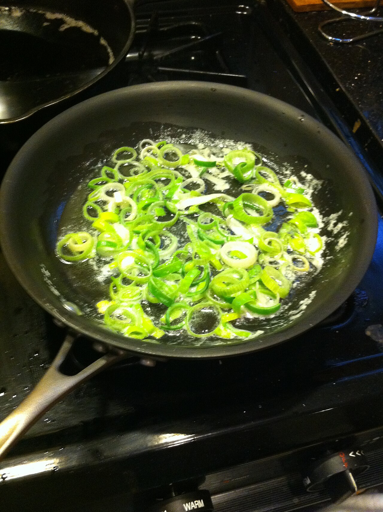 Chef frying food in a busy kitchen