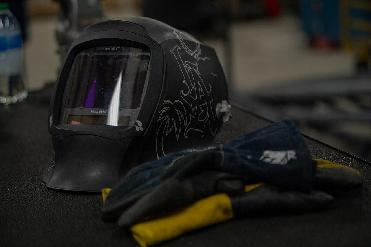 Welder working with sparks flying in a workshop